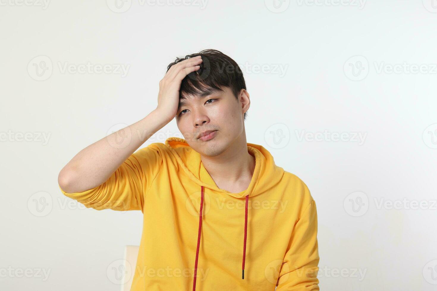 Young good looking Asian chinese malay man pose face body expression mode emotion on white background lost sad hand on head photo