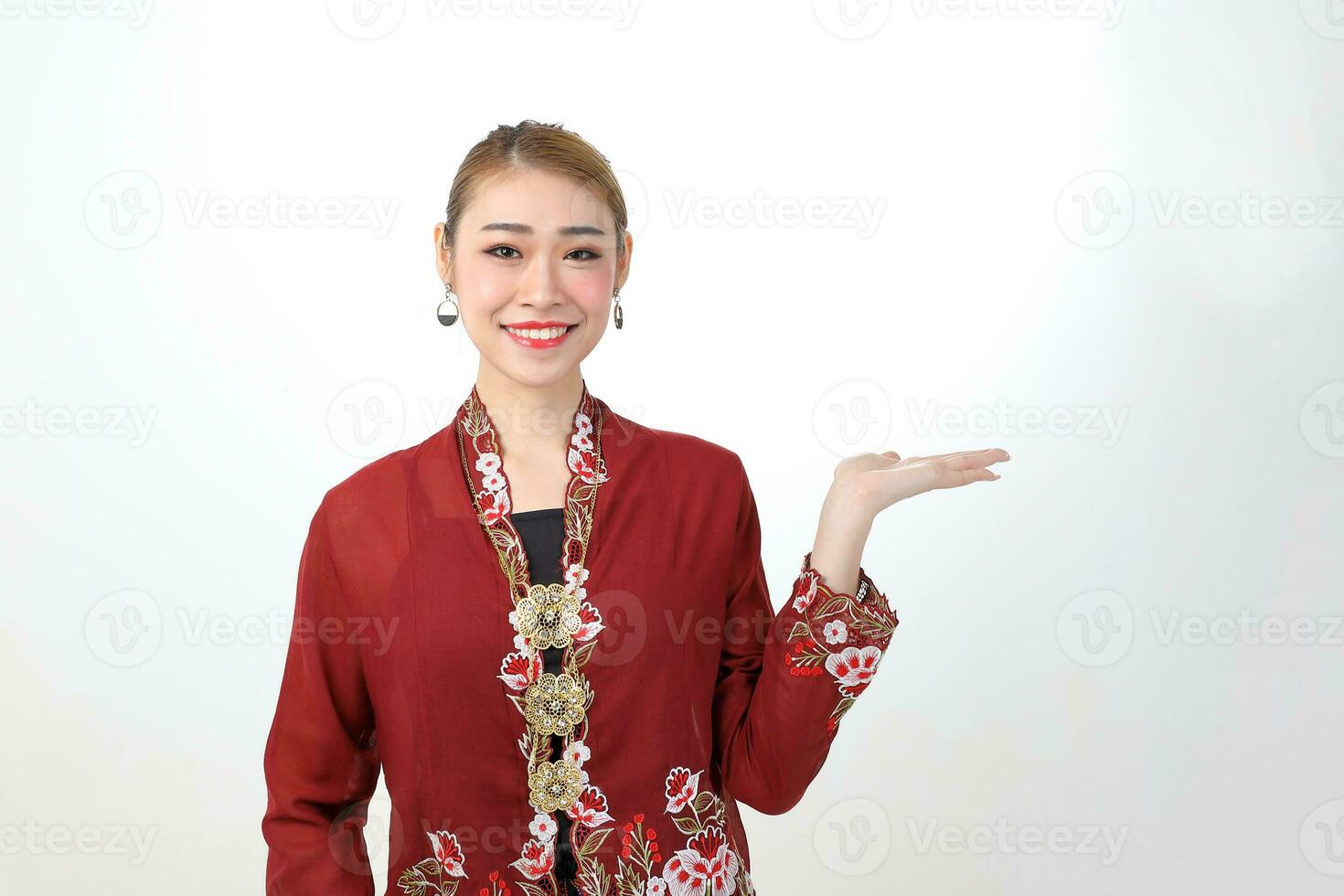 Asian woman traditional red maroon kebaya sharong on white background showing display hand palm photo