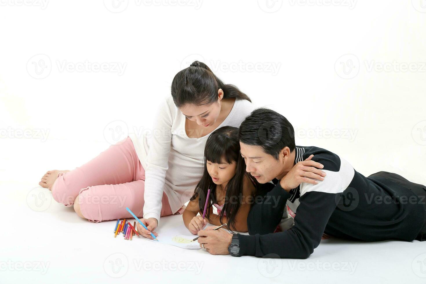South East Asian father mother daughter parent child study read write talk on floor white background pencil paper photo