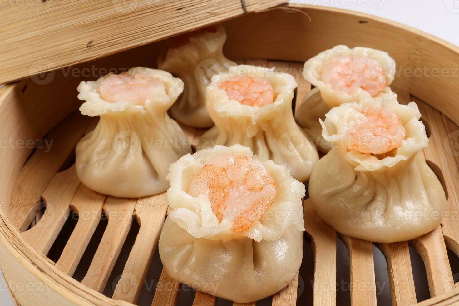 Prawn shrimp shaomai dim sum dumpling in bamboo steamer on white background photo