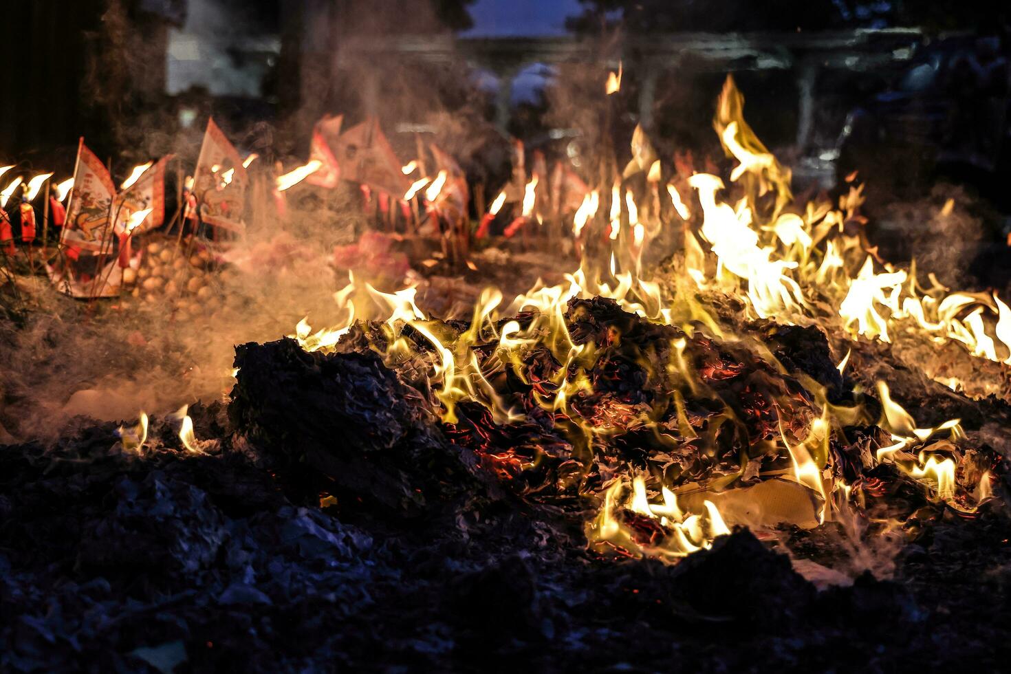 Chinese hungry ghost festival burning flame fire glowing ashes firefly colourful variety prayer paper joss money fake currency joss stick mini fag food fruit photo