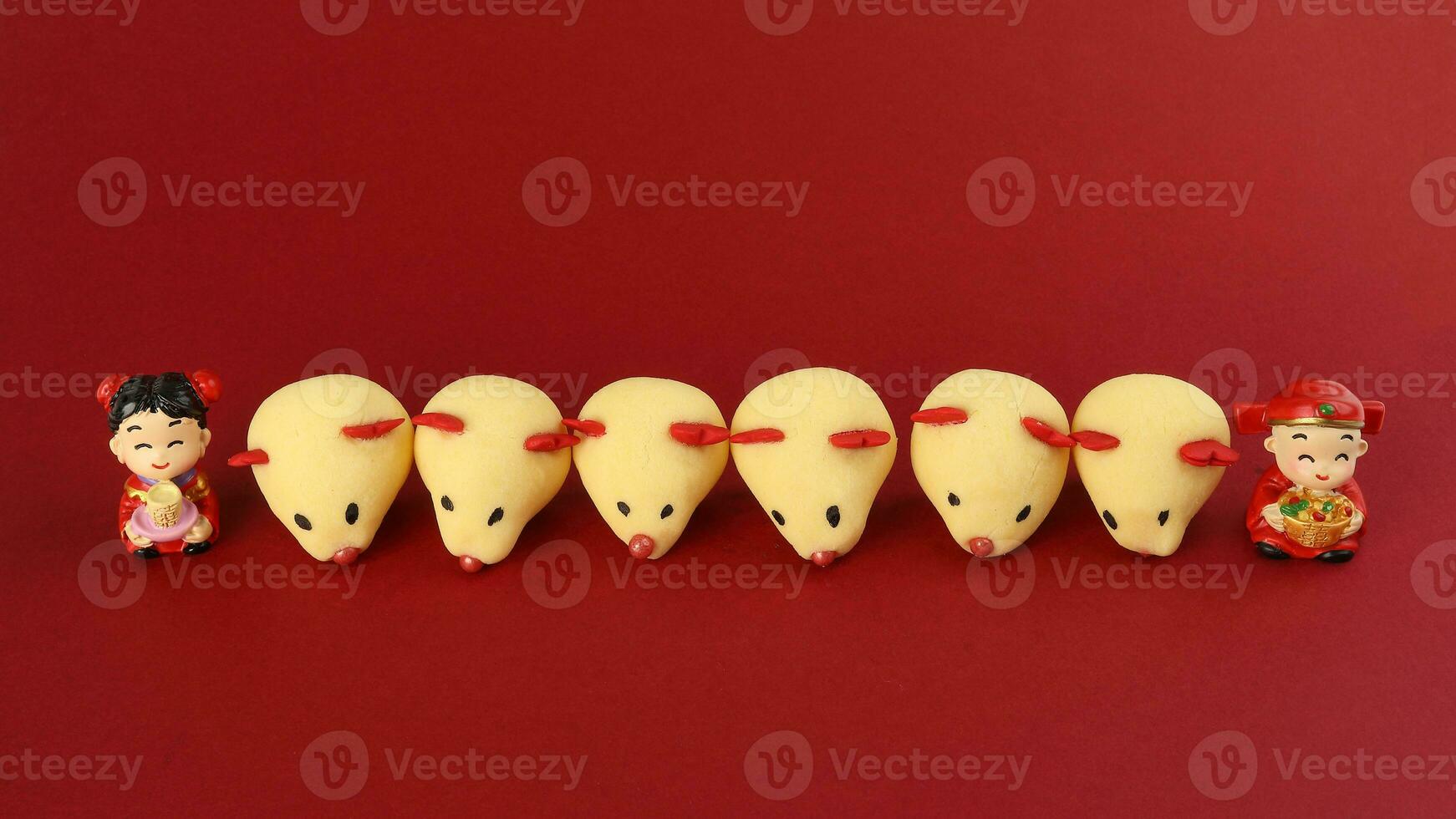 Chinese New Year rat mouse shaped cookie boy girl doll on red background photo