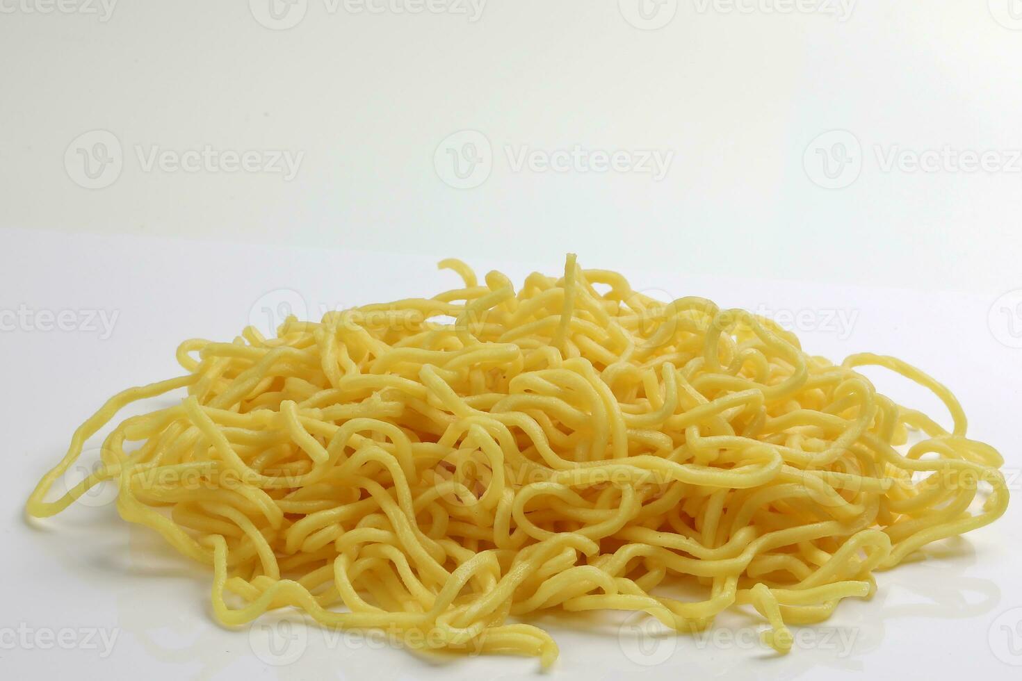 Fresh yellow egg noodle on whit background photo