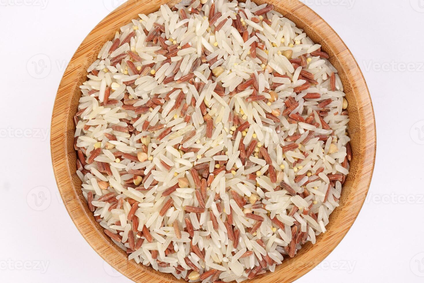 Mixed low glycaemic index healthy rice grain basmati millet buckwheat red rice in wooden bowl on white background top view photo