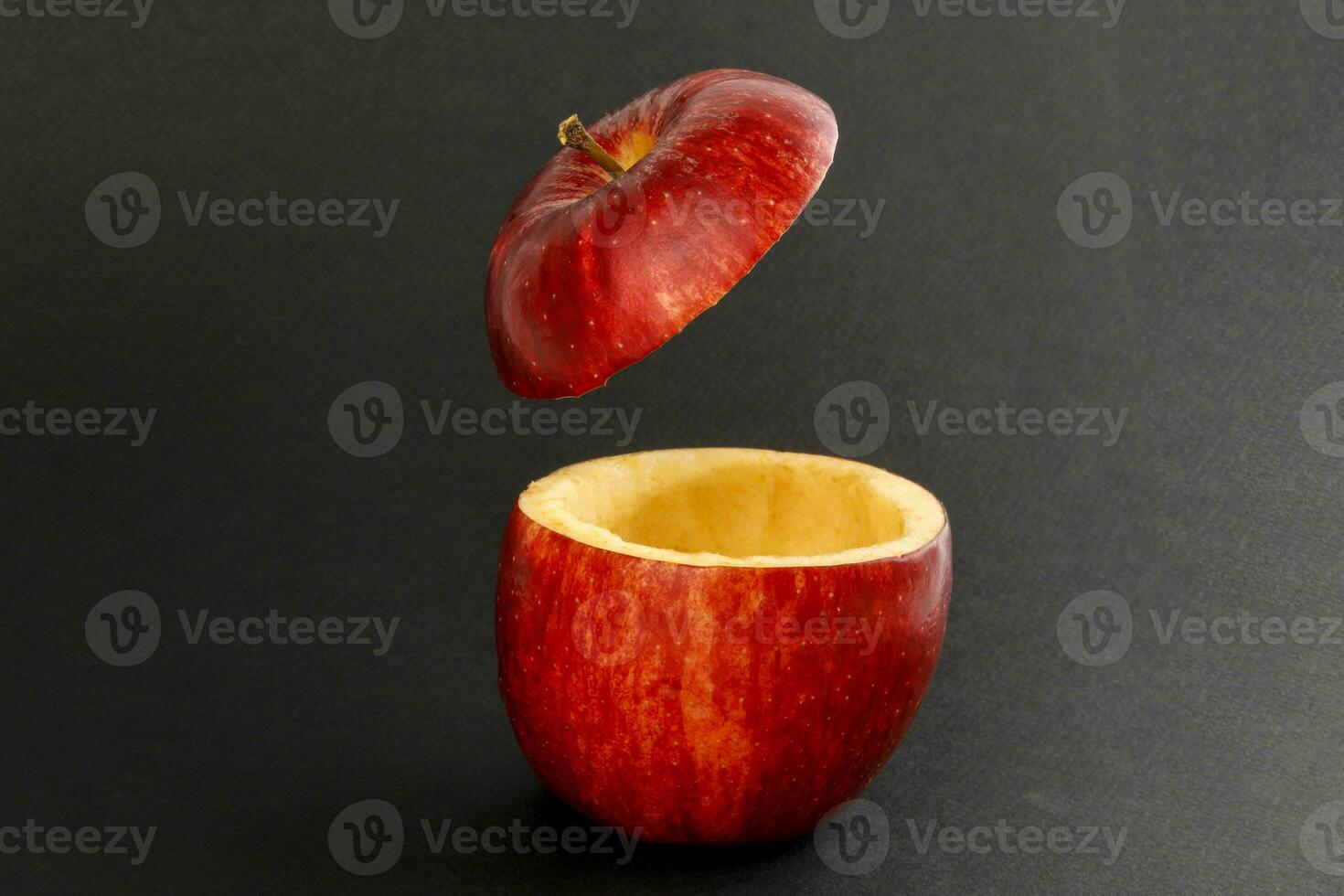 Health Red Cut Apple floating top slice juice drink idea concept on black background photo