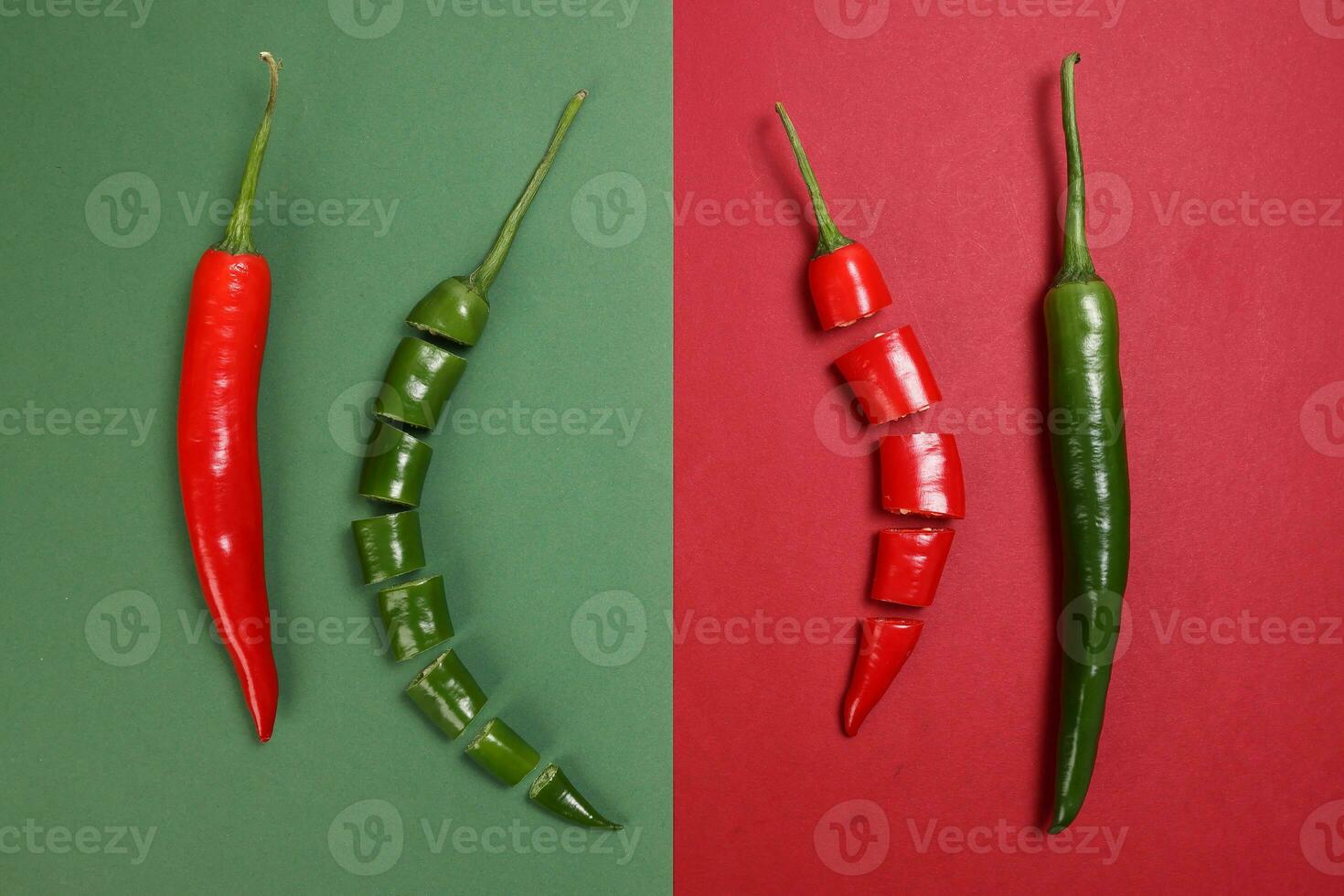 whole green red chilli pepper on green red paper background cut pieces seeds photo