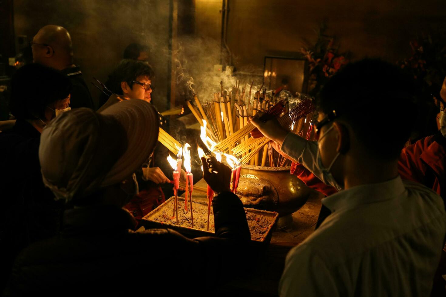 Hong Kong, Central-January 25, 2020  Devotees at Man Mo Temple for offerings and prayers for Chinese New Year.  In mist of protest and Novel coronavirus, 2019-nCoV, COVID-19. photo