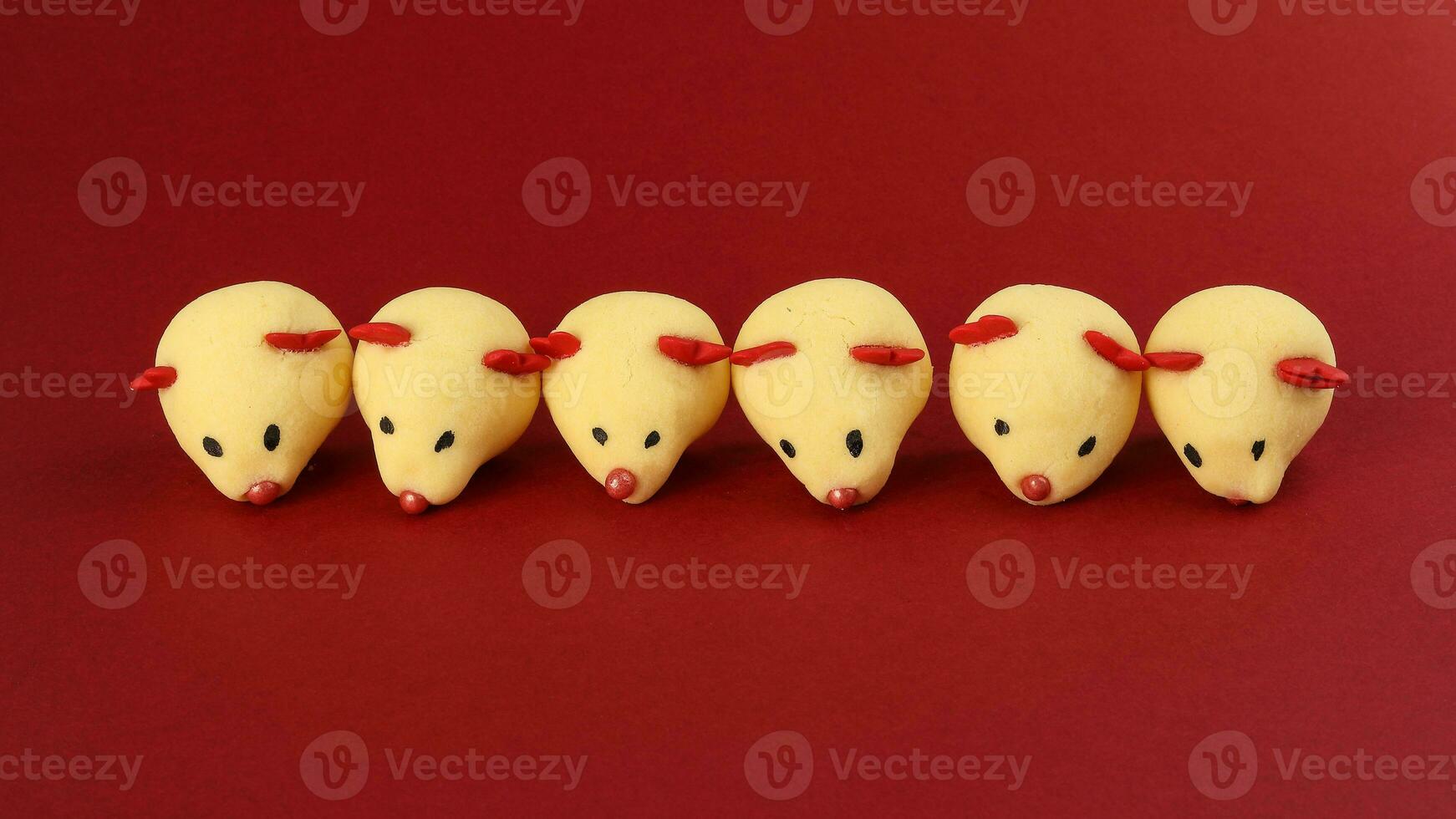 Chinese New Year rat mouse shaped cookie on red background photo