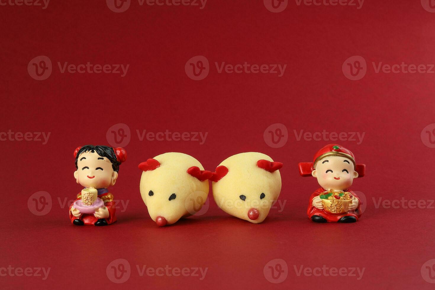 Chinese New Year rat mouse shaped cookie boy girl doll on red background photo