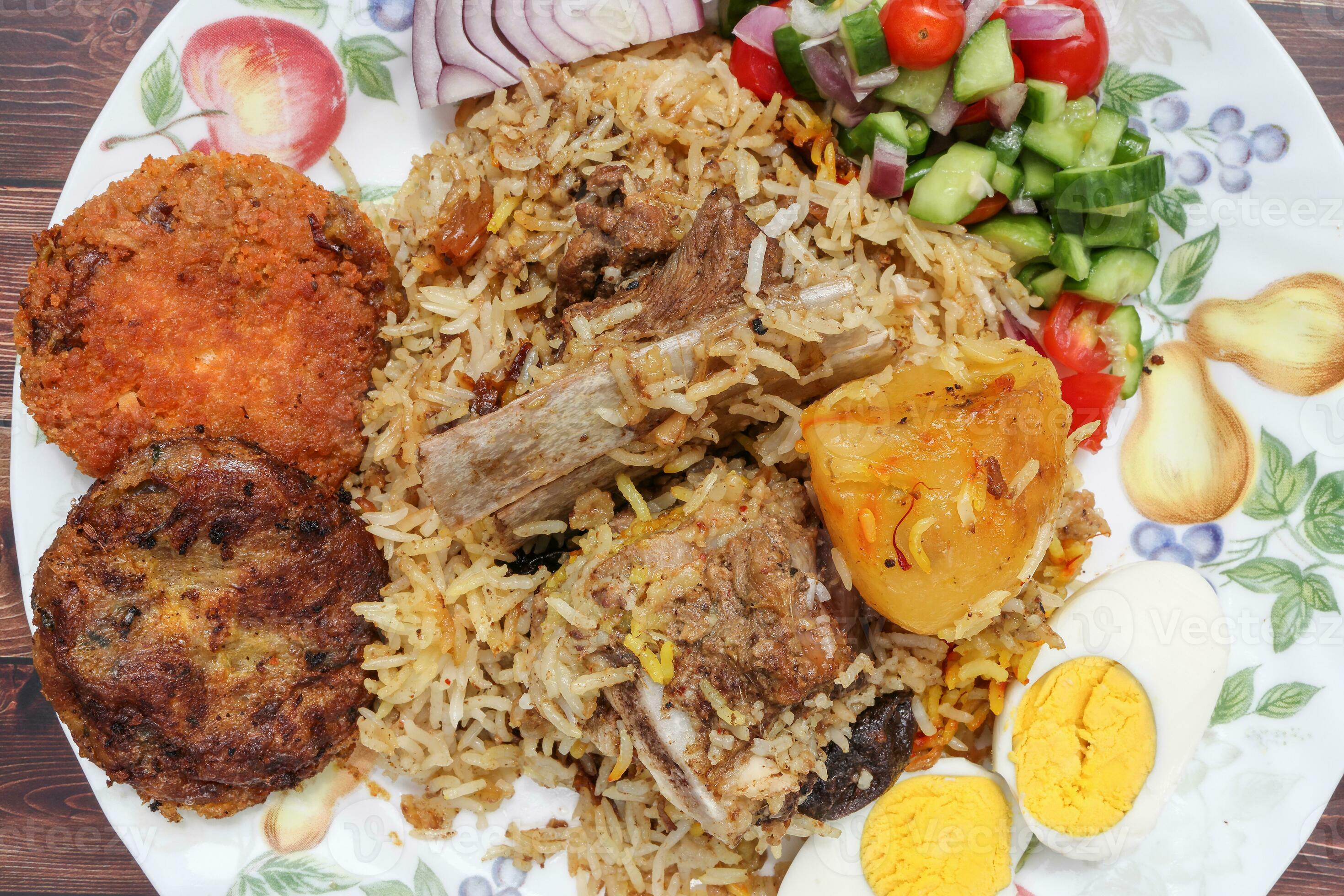 Home style mutton kacchi biryani with potato chop tomato cucumber onion