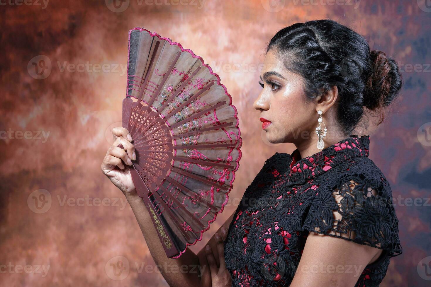 South east Asian Indian race ethnic origin woman wearing Chinese dress costume Cheongsam holding hand fan multiracial community on retro vintage background photo