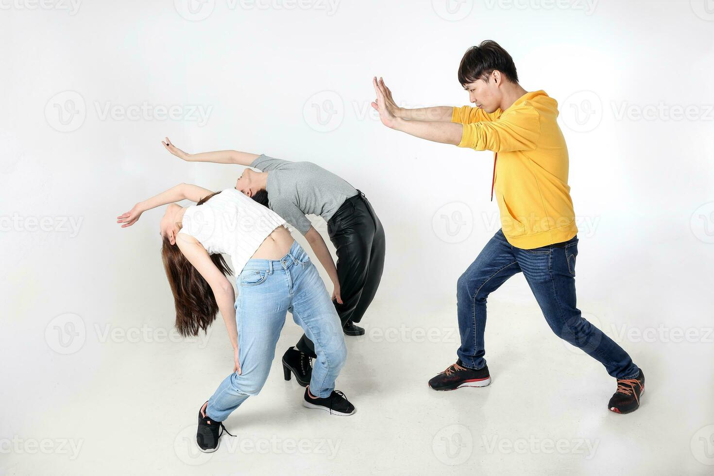 young south east asian mixed race man woman chinese malay man push in air two woman flay bent martial art exercise movement blown away photo
