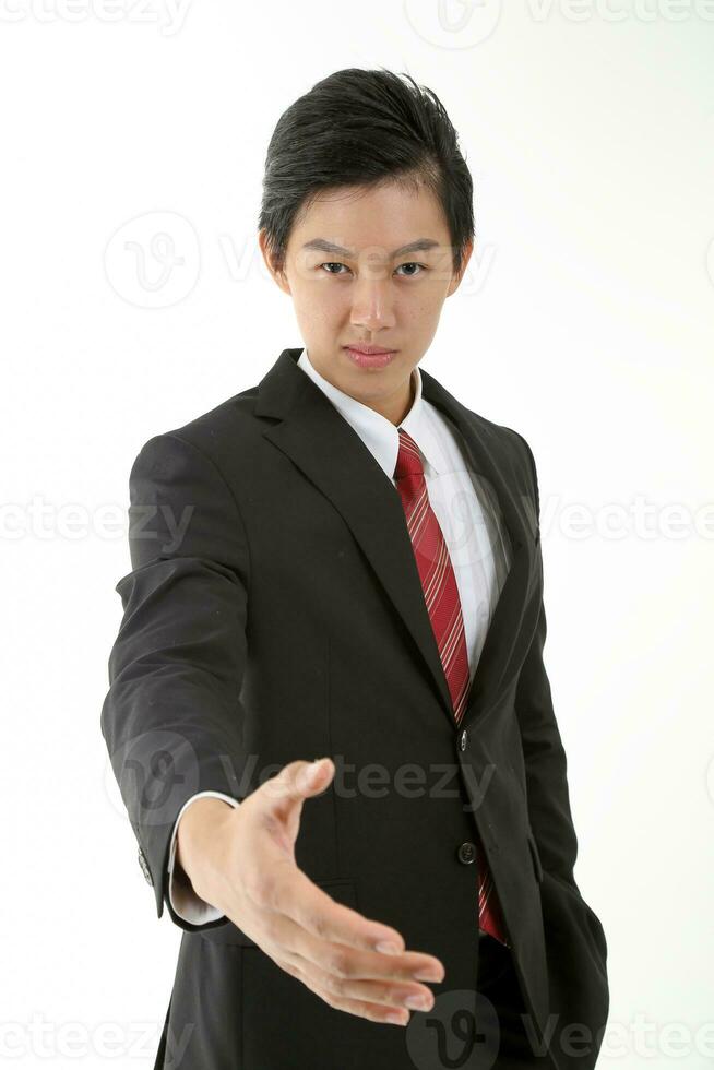 South East Asian young Chinese man wearing formal business office ware on white pose hand forward tor handshake greetings photo