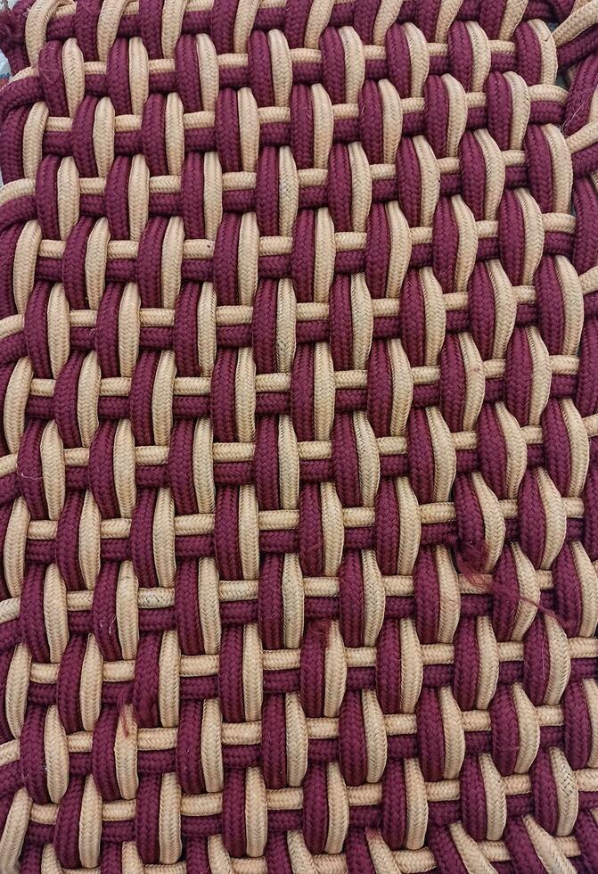Beautiful maroon thread floral embroidery work,knitted fabric closeup,background texture photo