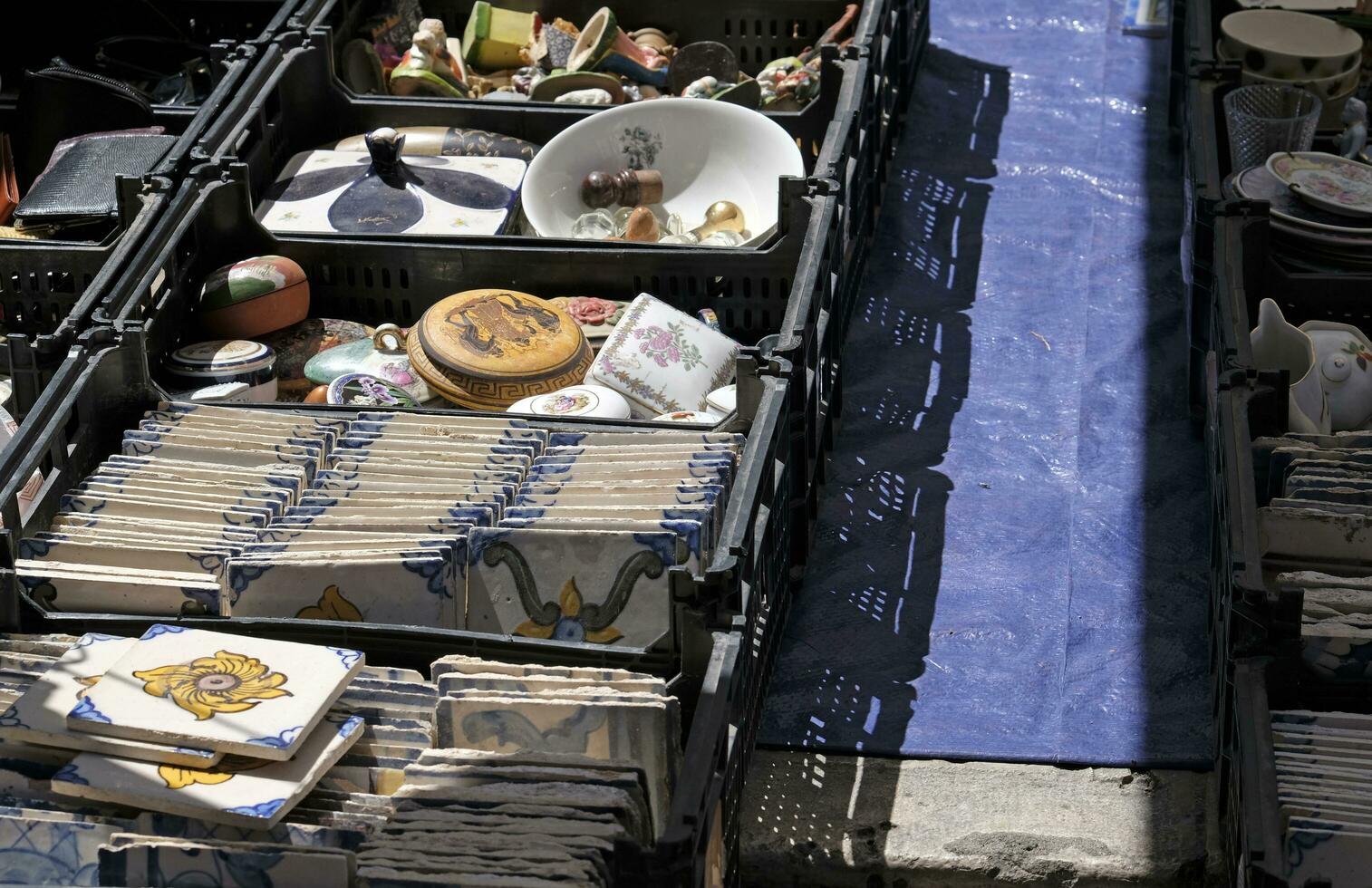 13 May 2023, Lisbon, Portugal - People examining the goods on display at the famous Feira da Ladra - Flea Market - in Lisbon, Portugal. photo