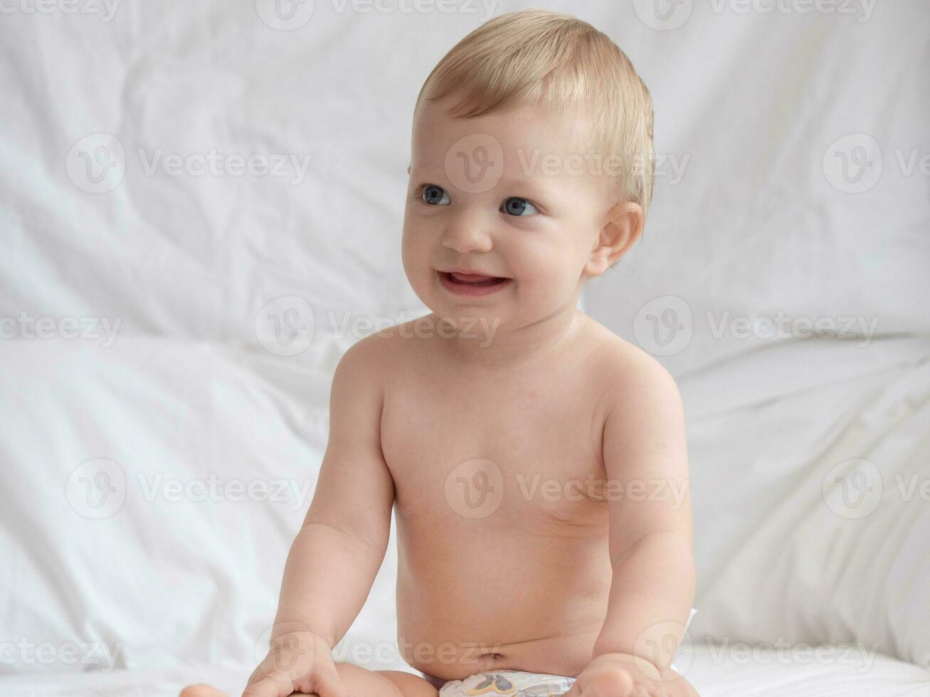 Cute Baby Sitting and Smiling on The Bed photo