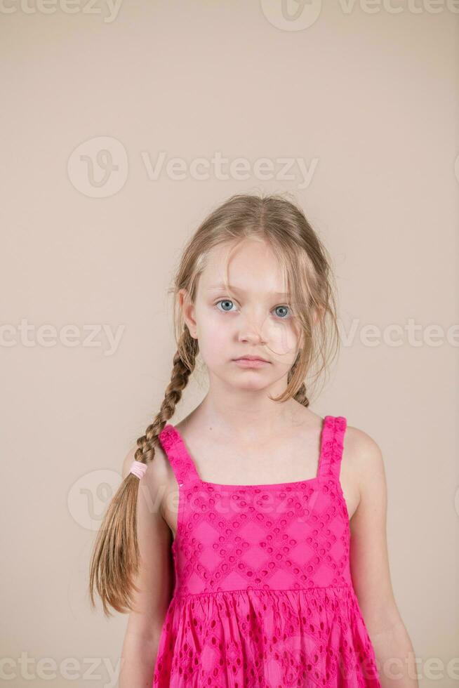 Little girl with pigtails and pink dress photo