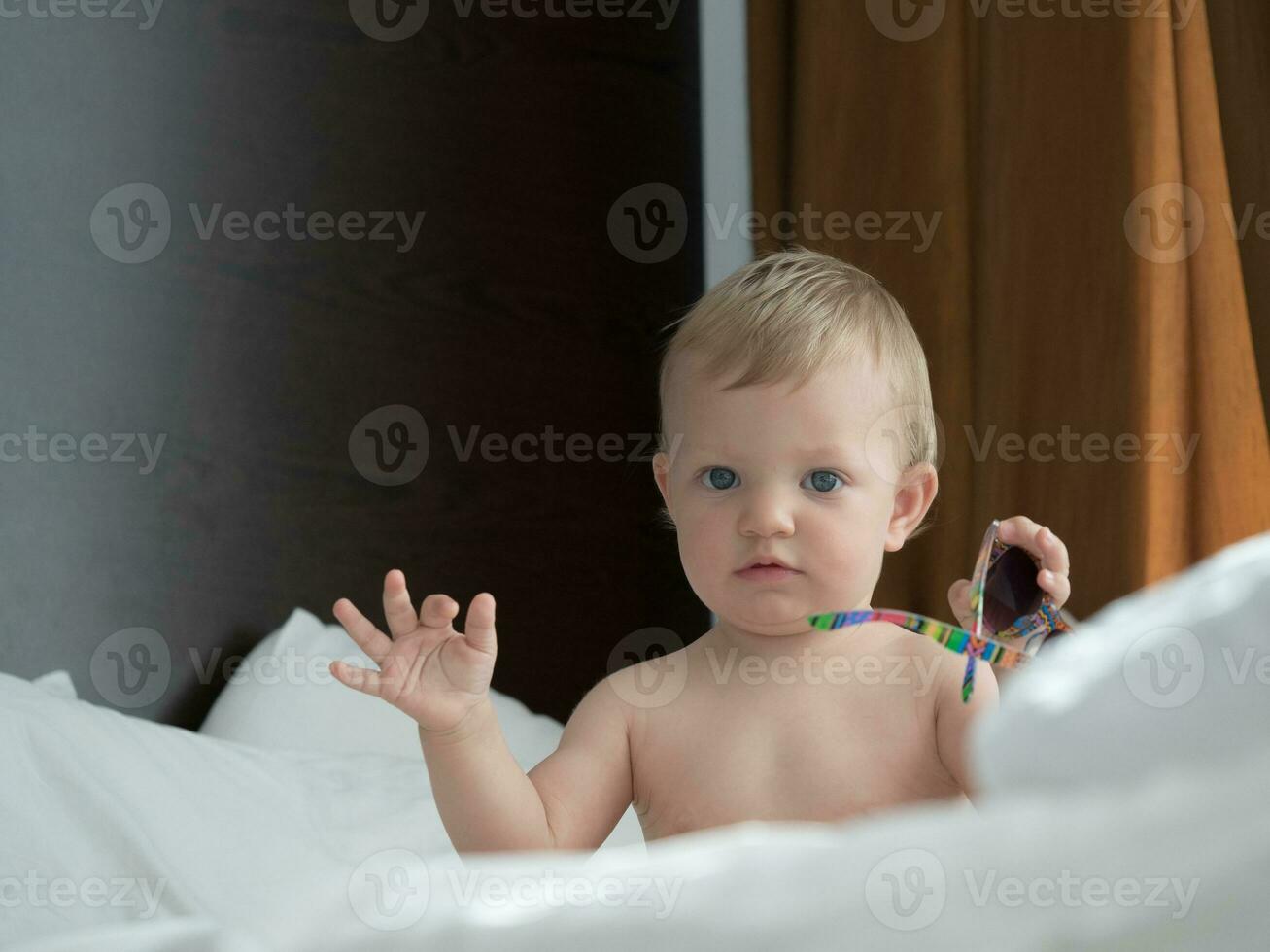 Baby Sitting on The Bed photo