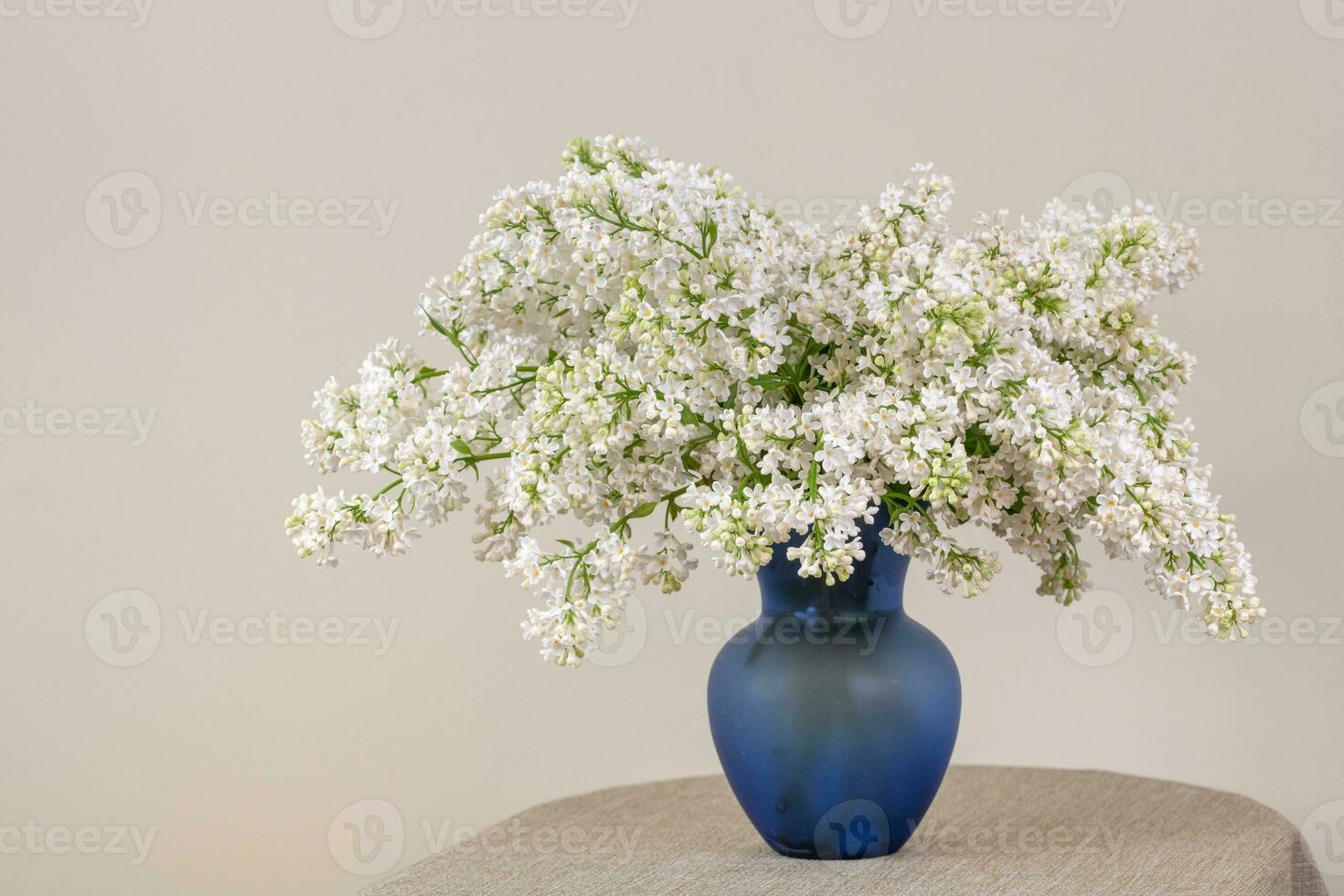White Lilac Flowers in Blue Vase photo