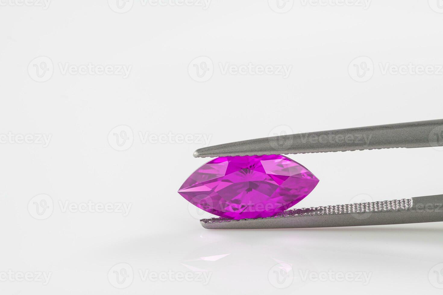Marquise Cut Purple Gemstone in Jewelry Tweezers photo