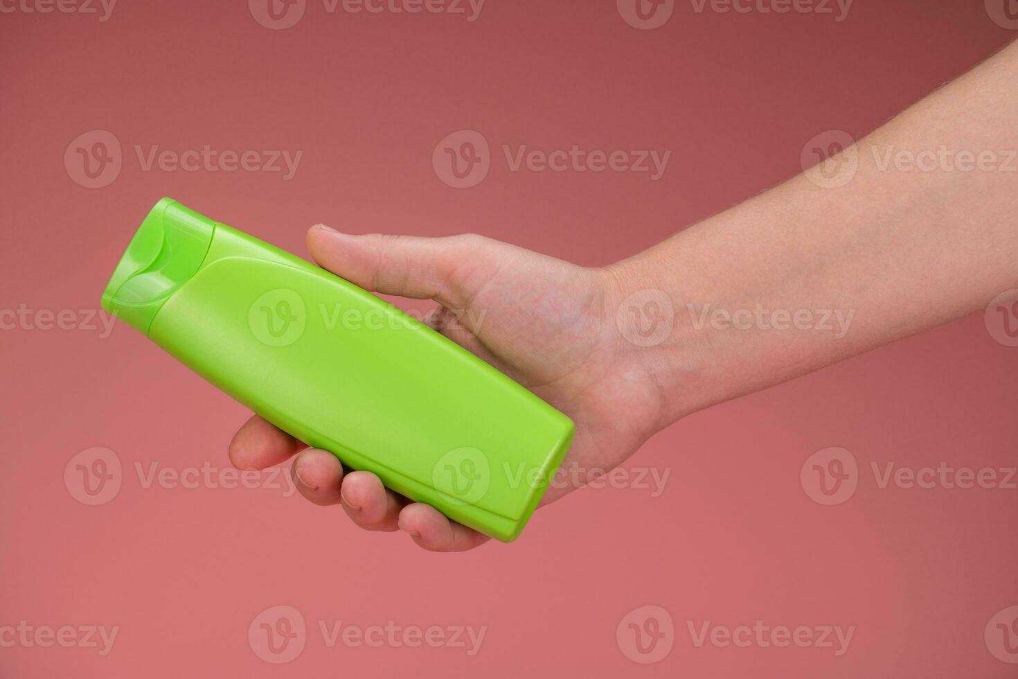 Blank Label Shampoo Green Bottle Holding in Hand photo