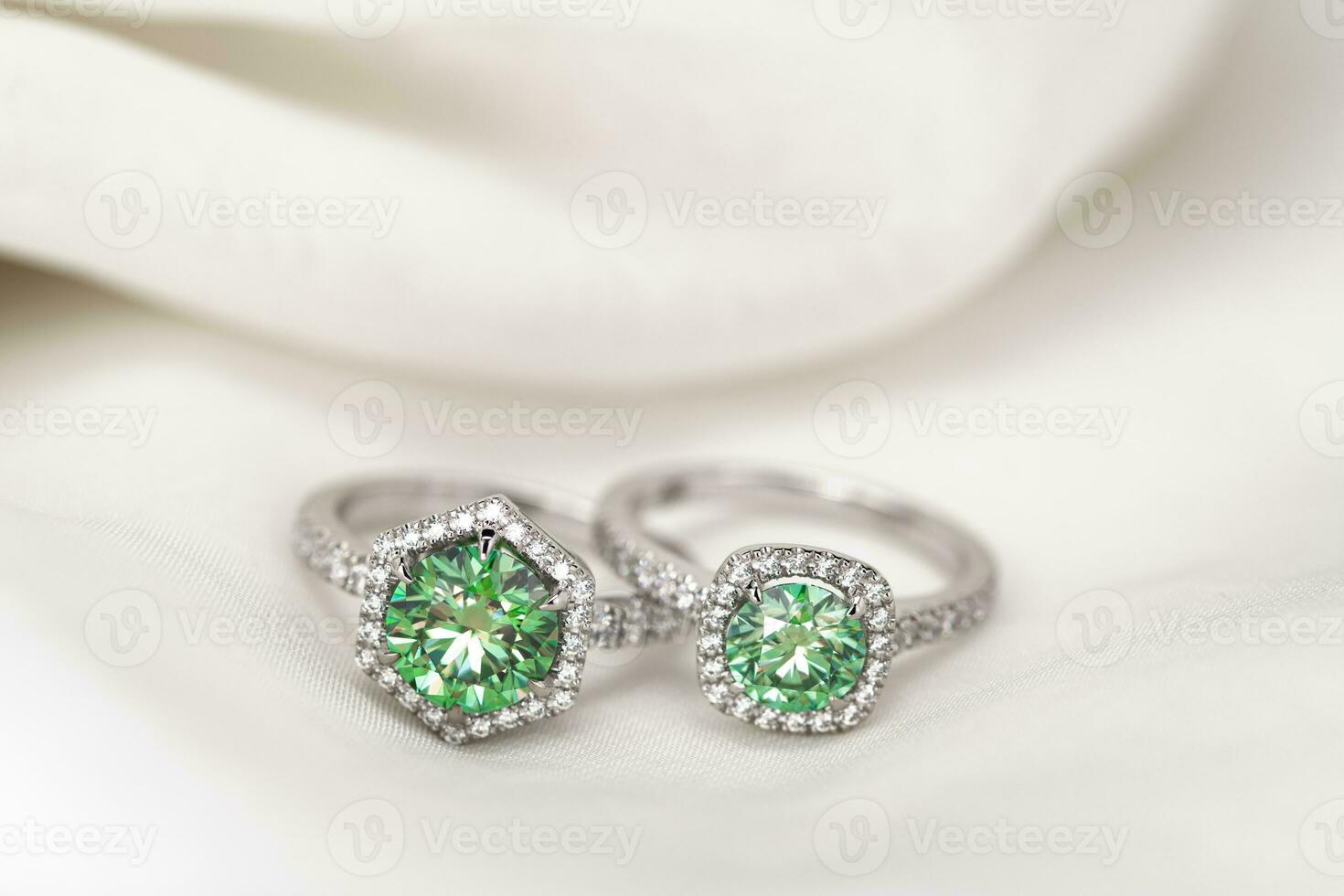 Engagement Emerald Ring on White Fabric background photo