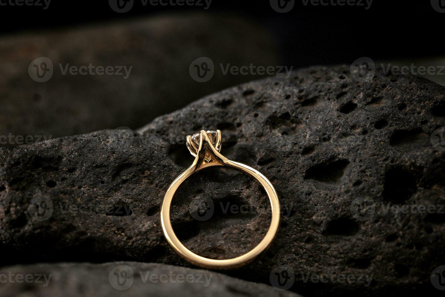 Gold Solitaire Diamond Ring on Black Stone photo