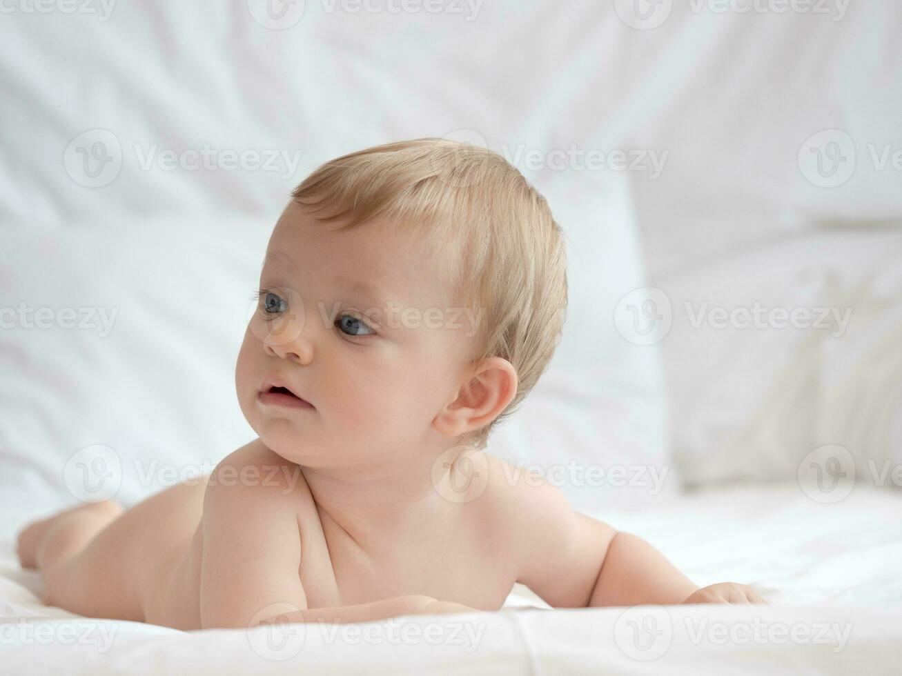 Blond Cute baby Lying on bed photo