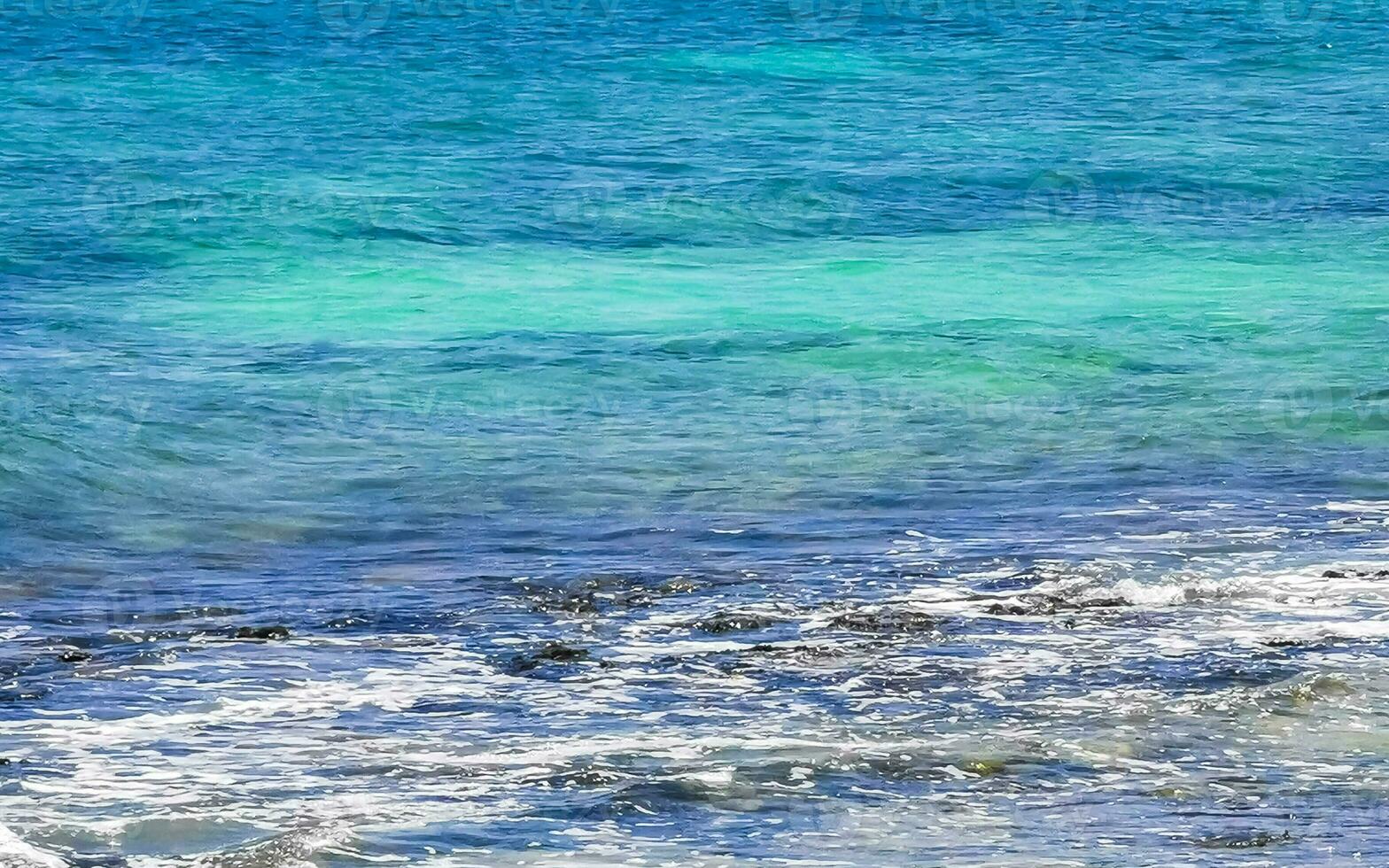Stones rocks corals turquoise green blue water on beach Mexico. photo