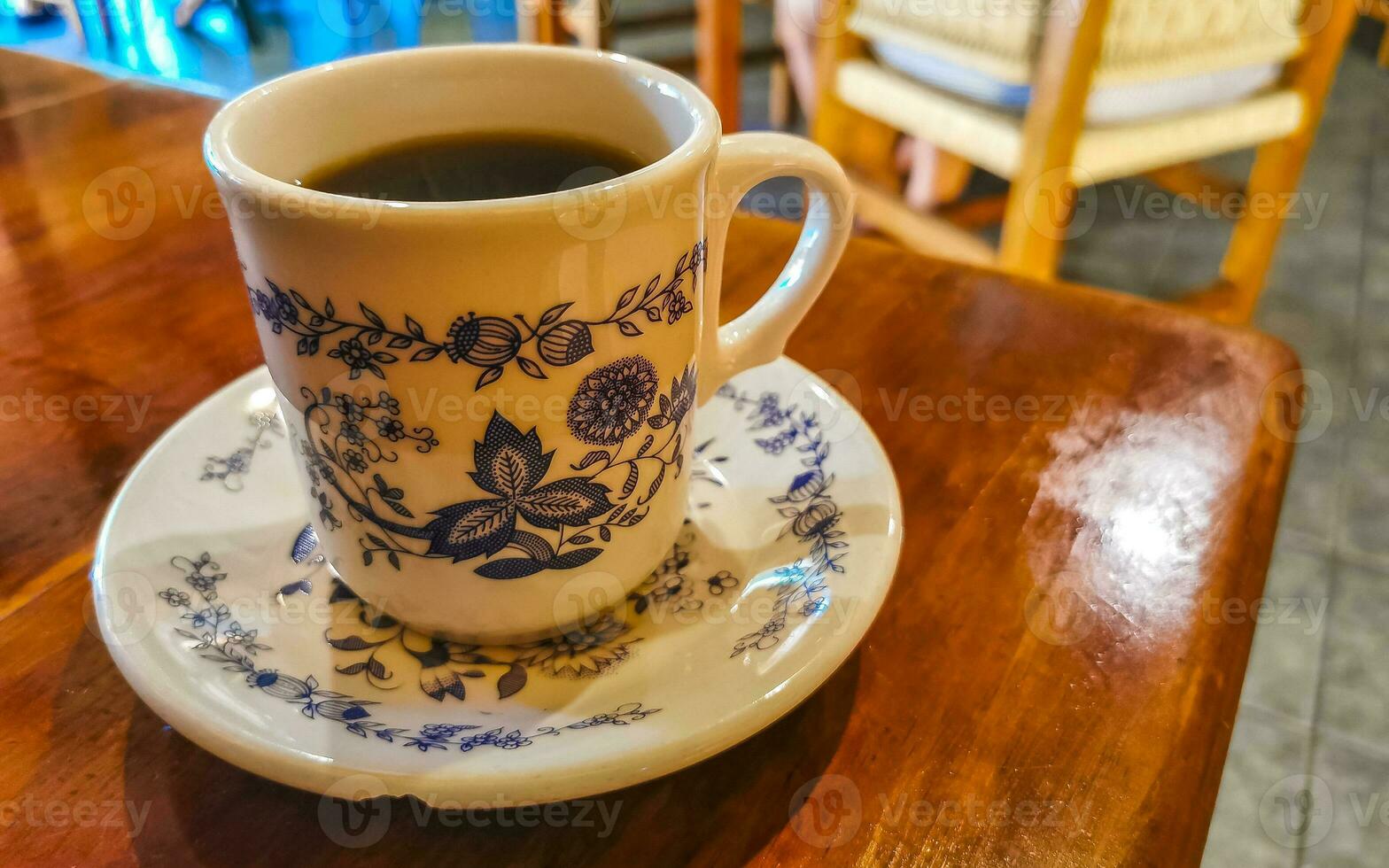 Blue white cup pot with black coffee wooden table Mexico. photo