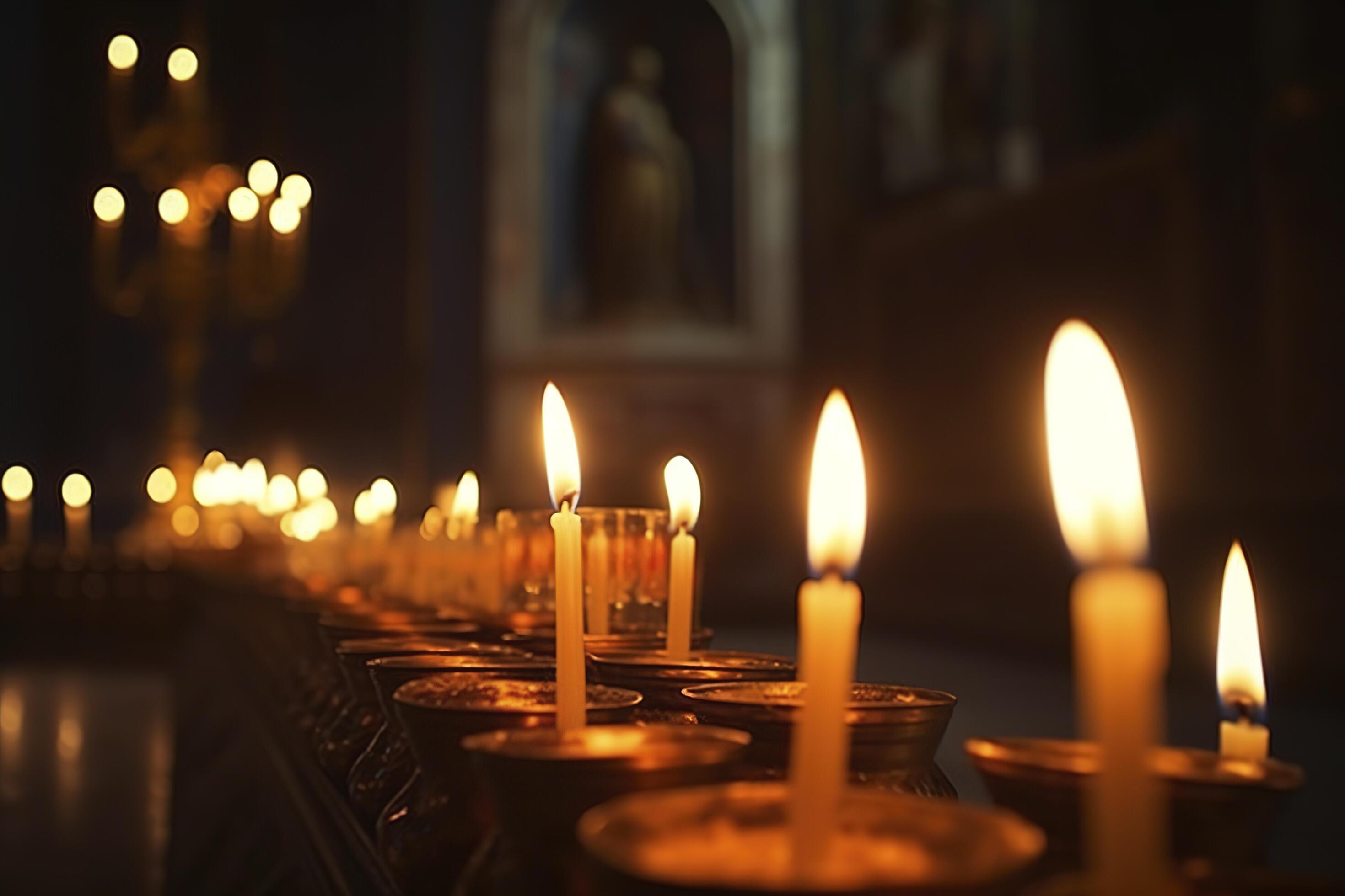Candles in a Christian Orthodox church background. Flame of candles in the dark sacred interior