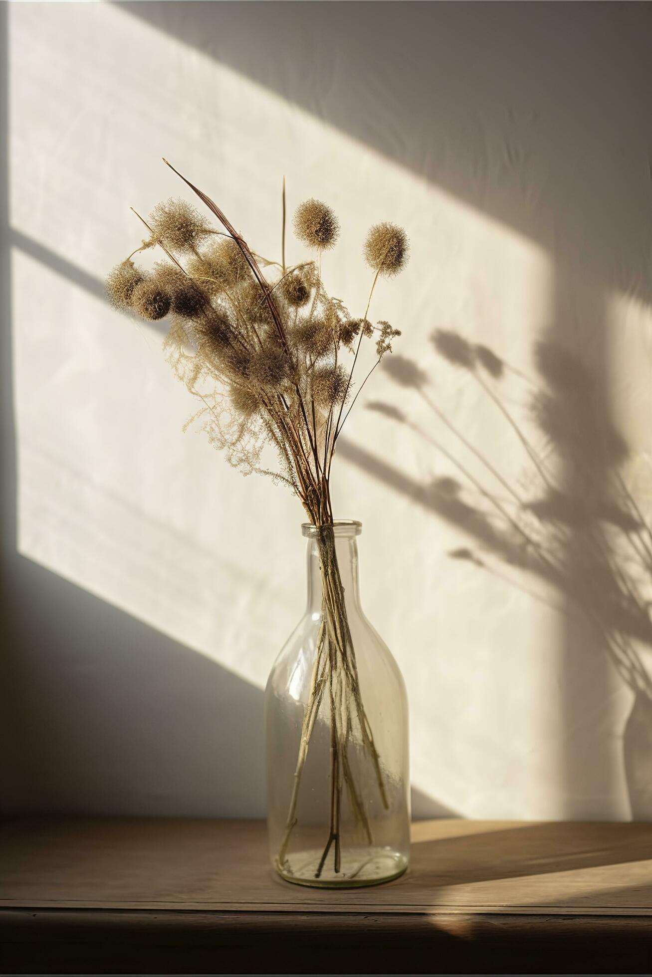 Dried meadow grass bouquet in clear glass bottle aesthetic sun