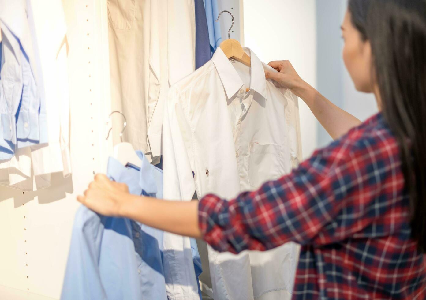 hembra mano elegir ropa para comprobado modelo algodón color de el camiseta y comparar calidad en el estante en paño tienda a Departamento almacenar. foto