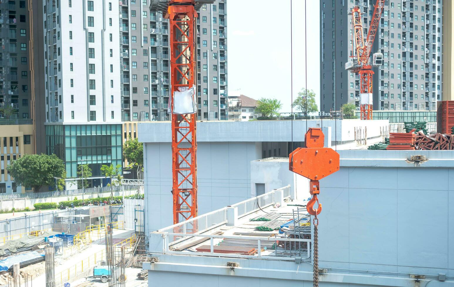 View of the construction site and red cranes for building modern residential area photo