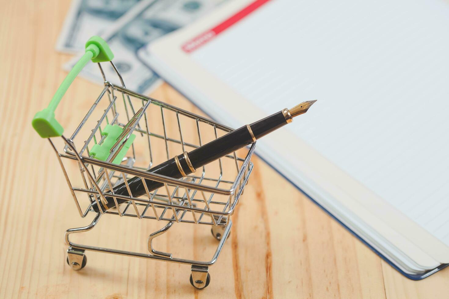 online business concept fountain pen in shopping cart. photo