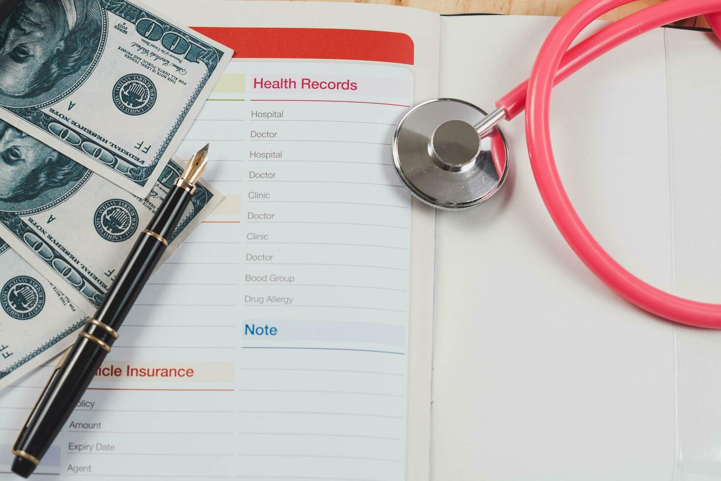 Health records in book note with fountain pen wooden background. photo