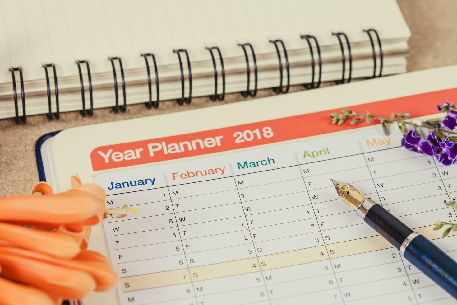 personal organizer or planner with fountain pen on wood table. photo