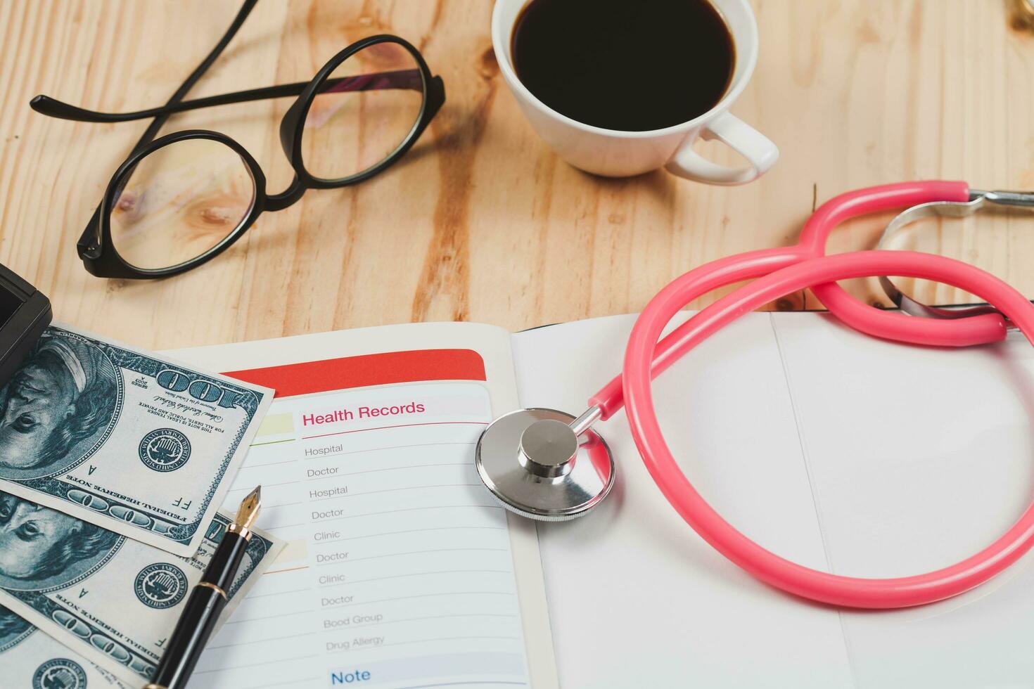 Health records in book note with fountain pen wooden background. photo