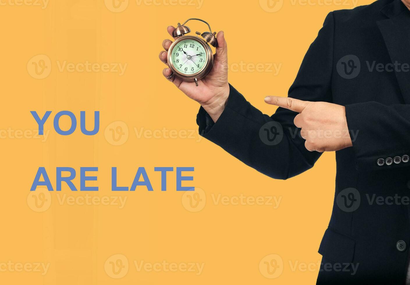 Business man holding alarm clock and point to time,Business working time. photo