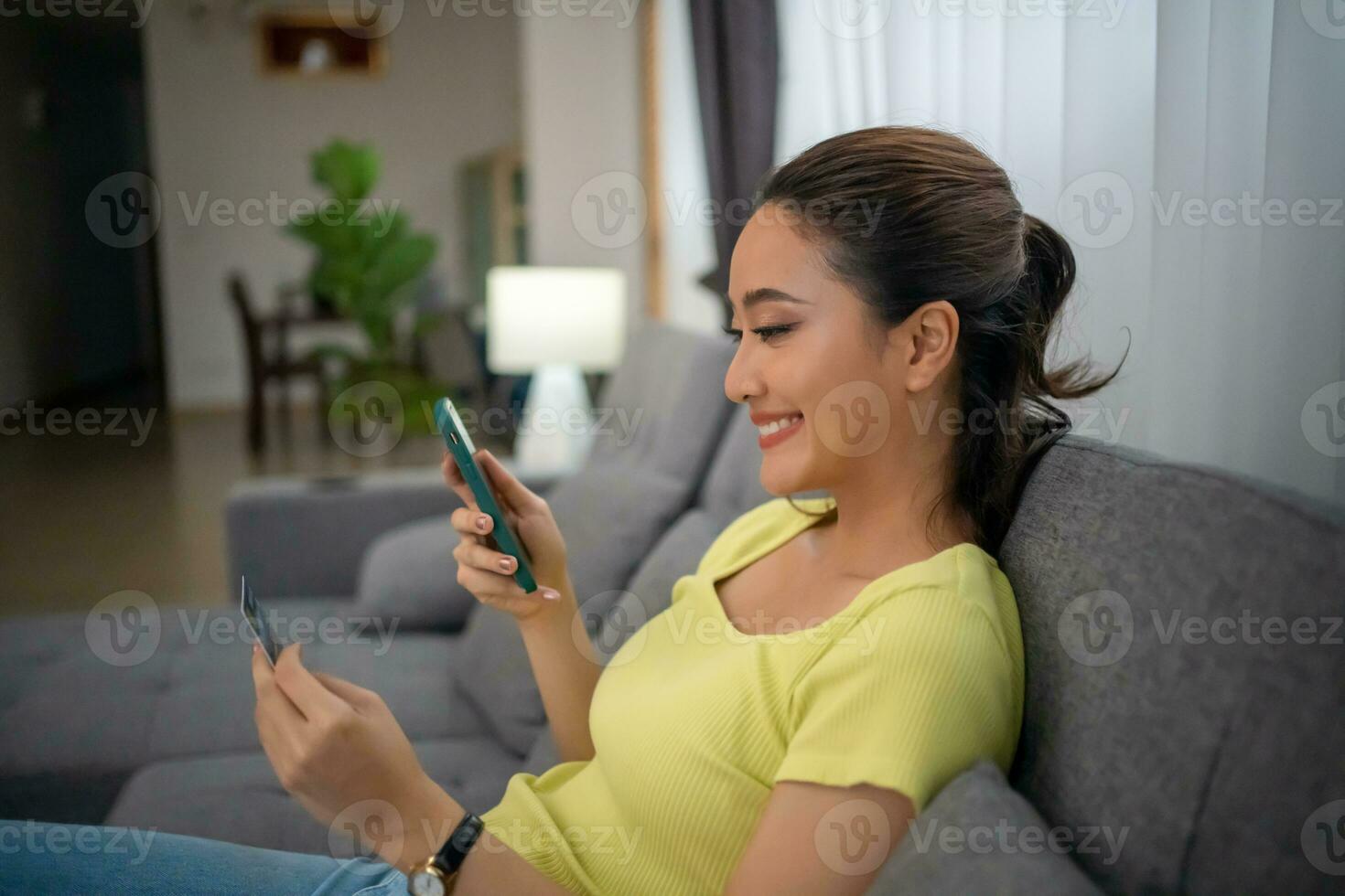 Women shopping on Smart phone and Laptop with Credit card at home photo