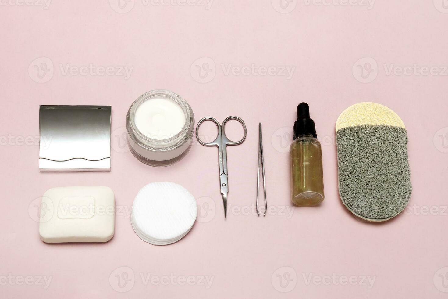 set of personal care accessories on a pale pink background photo