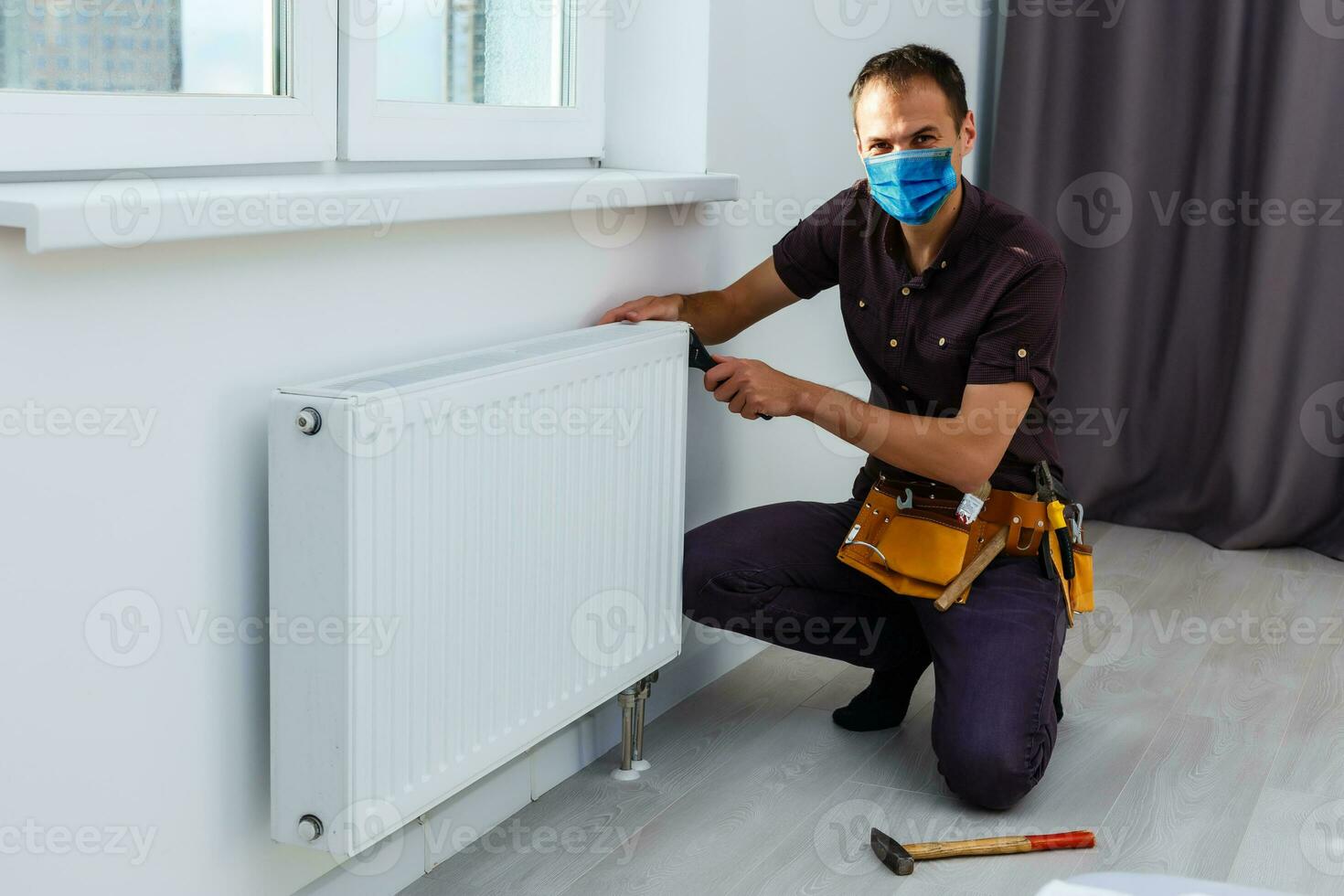 Worker in protective workwear with tools, isolated photo