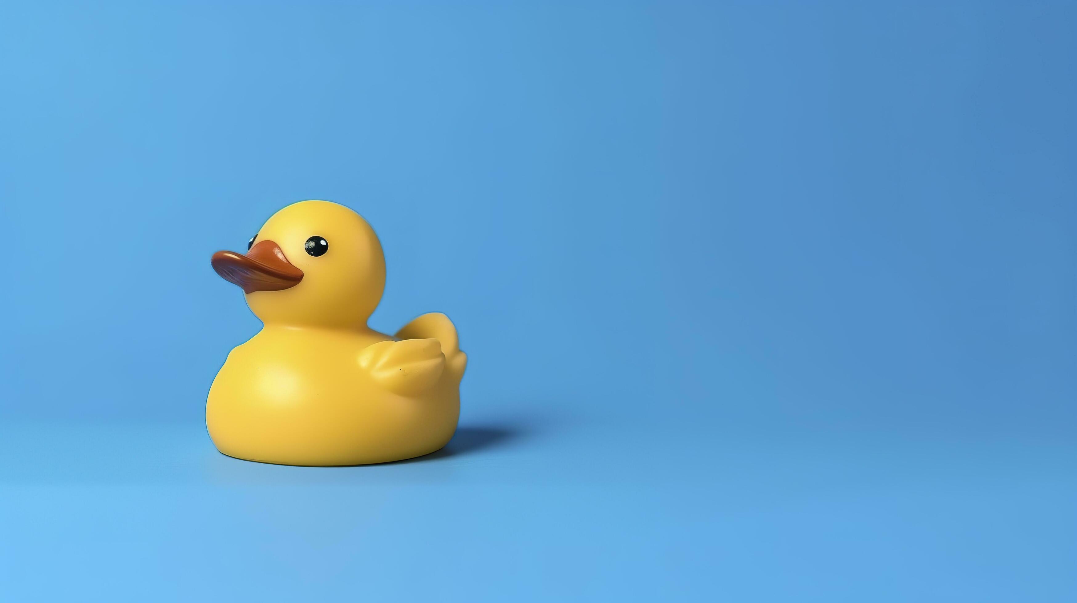 Yellow rubber duck toy against blue background, generate ai 24494348
