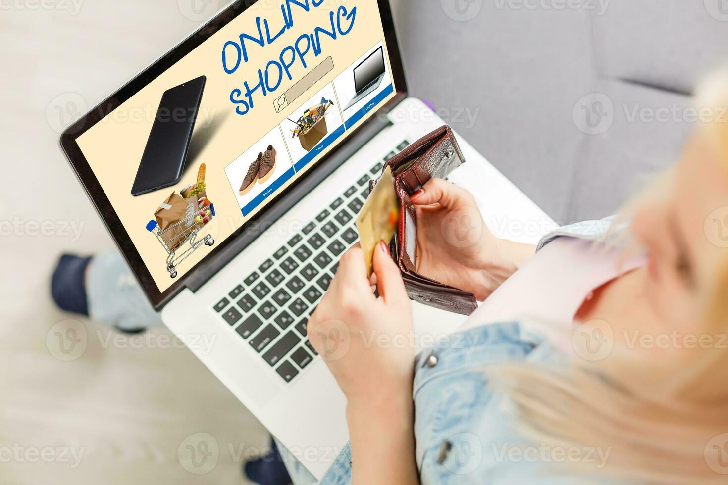 shopping, technology and internet concept young girl shopping with laptop computer on a fictional shop photo