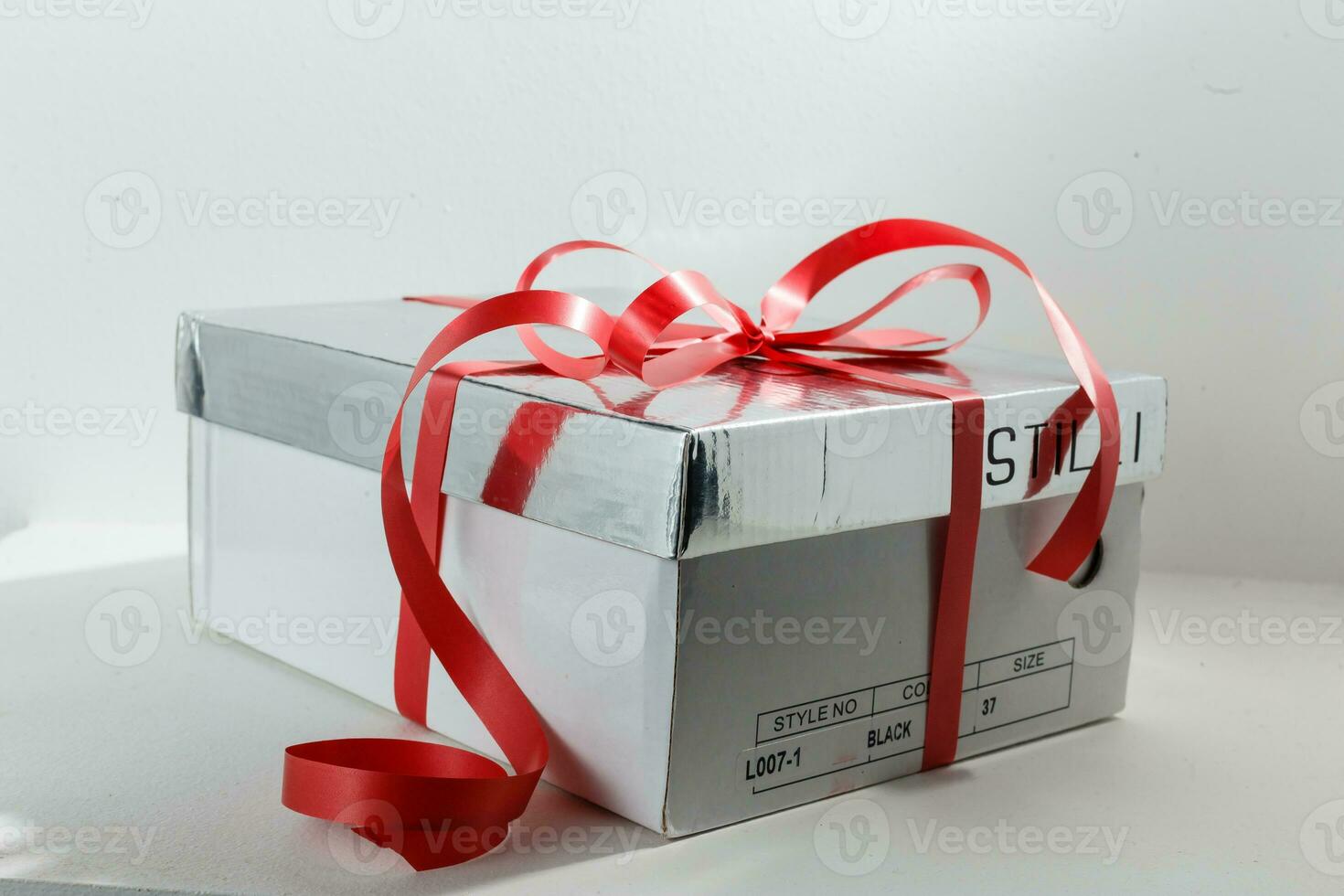 Gift box with ribbon end bow isolated on the white background, clipping path included. photo