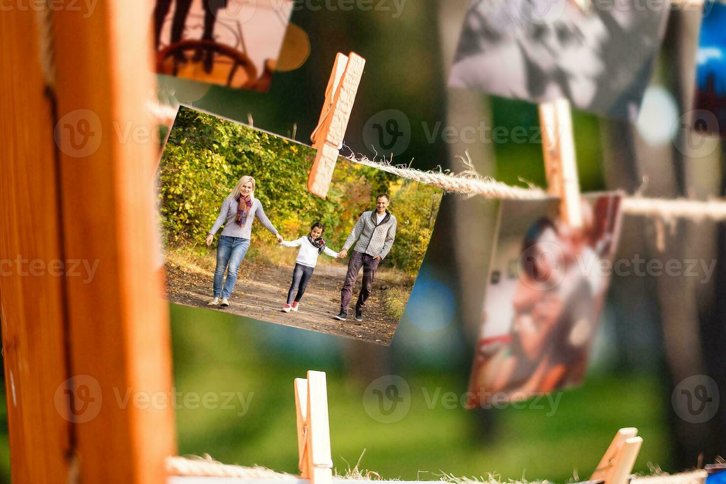 autumn photos are hanging on a clothespin