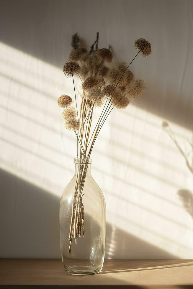 Dried meadow grass bouquet in clear glass bottle aesthetic sun light shadows on neutral wall, minimalist floral interior design , generate ai photo