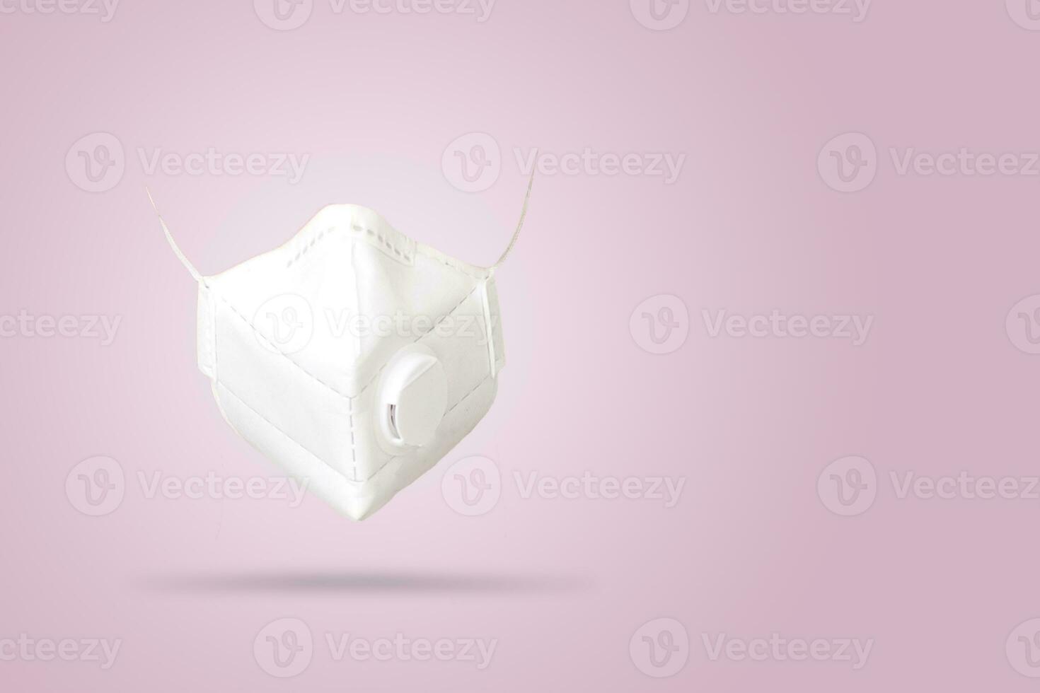 White n95 mask on pink background, n95 respirator with ventilation valve, anti-haze mask, photo