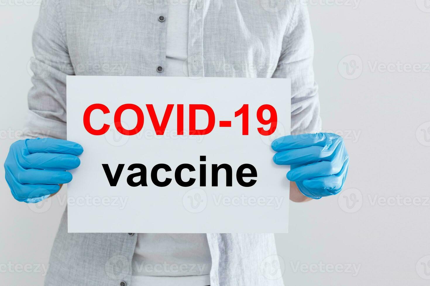 Male holding inscription COVID 19 vaccine. photo