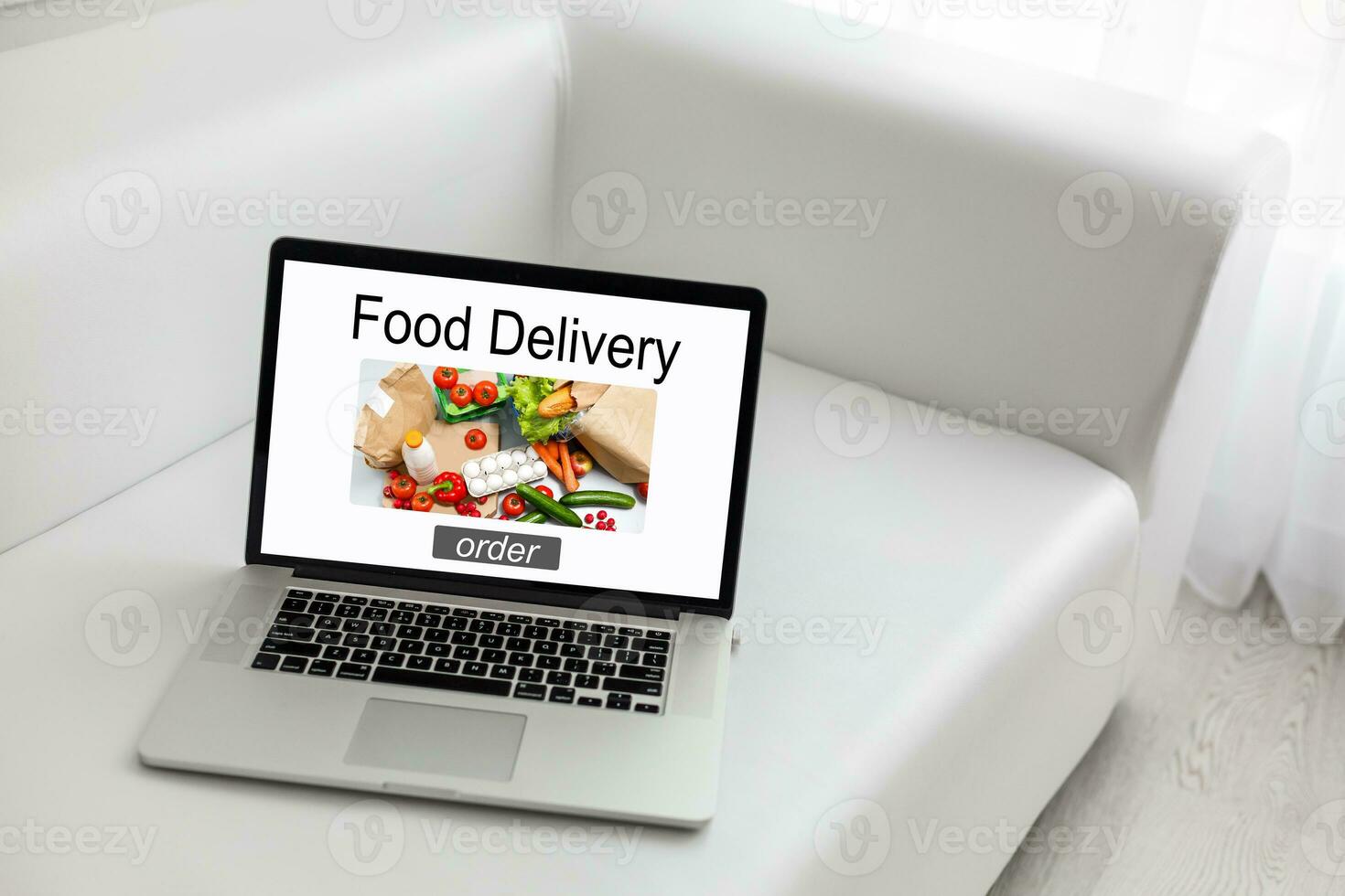 Food take away website in a laptop screen. Lunch at the office. photo